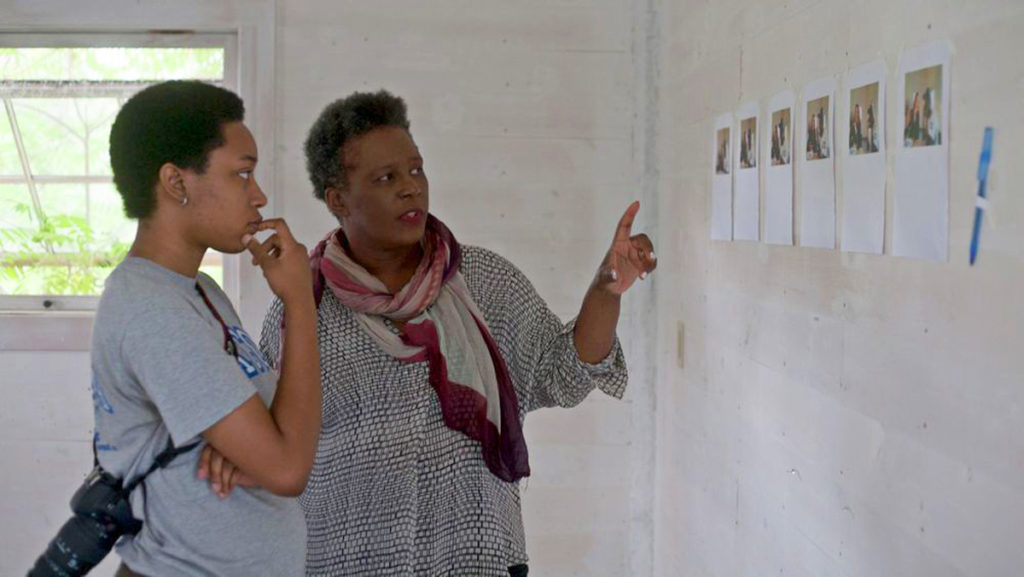 From left, Kim Nicolas 17 and Claudia Rankine, Image Text MFA Program fellow, work on an art project in collaboration with other Ithaca College students.