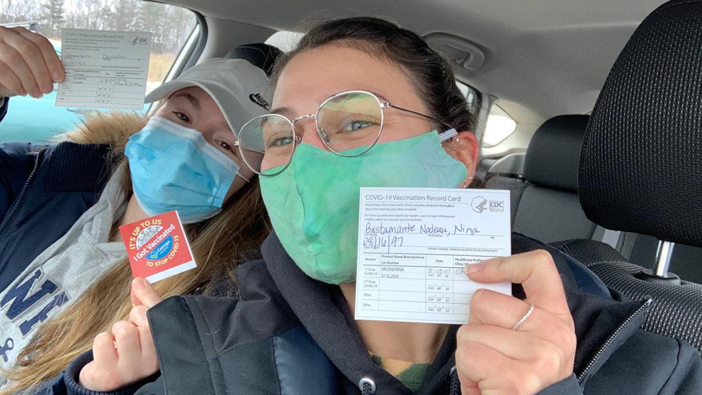From left, Danielle Johanson and Nina Bustamante, 6th year Physical Therapy students showing off their COVID-19 vaccination cards 