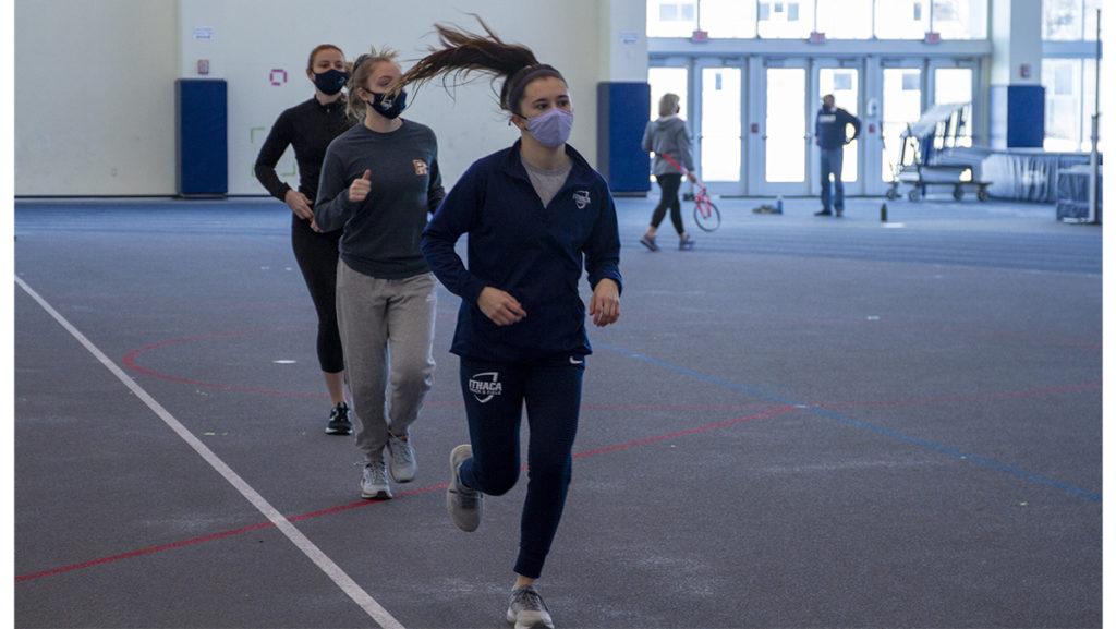 From left, senior Julia Nomberg, sophomore Jamie Rossig and junior Meghan Matheny at track practice at the Athletics and Events Center on Feb. 21.