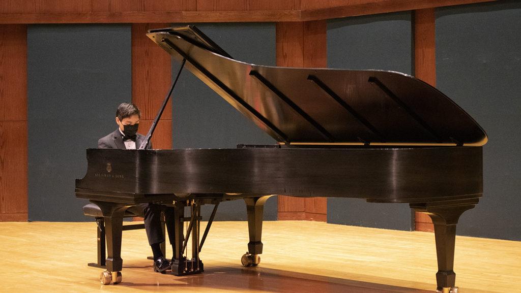 Junior Harris Andersen, a piano performance major, plays the piano March 20 in Hockett Family Recital Hall for his junior recital. In-person concerts have returned to the School of Music.