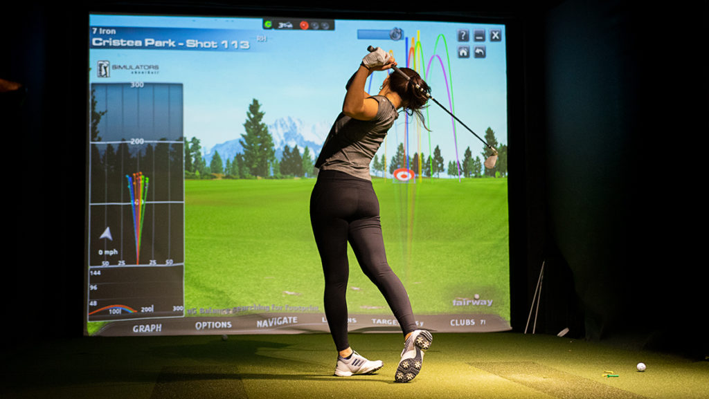 Sophomore+Christea+Park+works+on+her+drive+in+the+course+simulator+March+5.+The+simulator+was+installed+for+the+Ithaca+College+golf+team+in+Spring+2016.