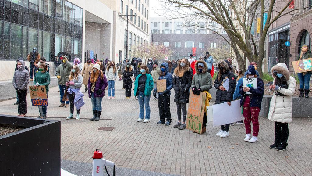 On April 22, a large crowd gathers on The Commons despite the snow to participate in the Earth Day Rally organized by Sunrise Ithaca. 
