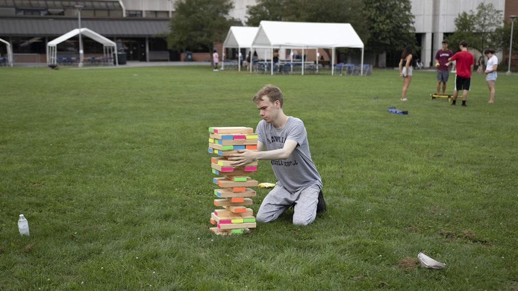 Sophomore Anatol De Nevers plays giant jenga at Wellness Day, part of the two-week long Fall Welcome. The Aug. 29 event, which was open to all students, took place on the Campus Center Quad and comprised a variety of lawn games.