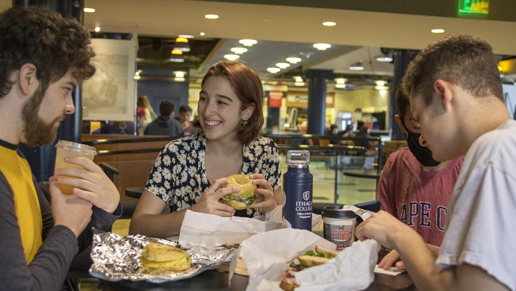 Junior Maddy Leitner enjoys a Jonah’s Jive sandwich, one of the plant-based options from Ithaca Bakery on Sept. 6 in IC Square.