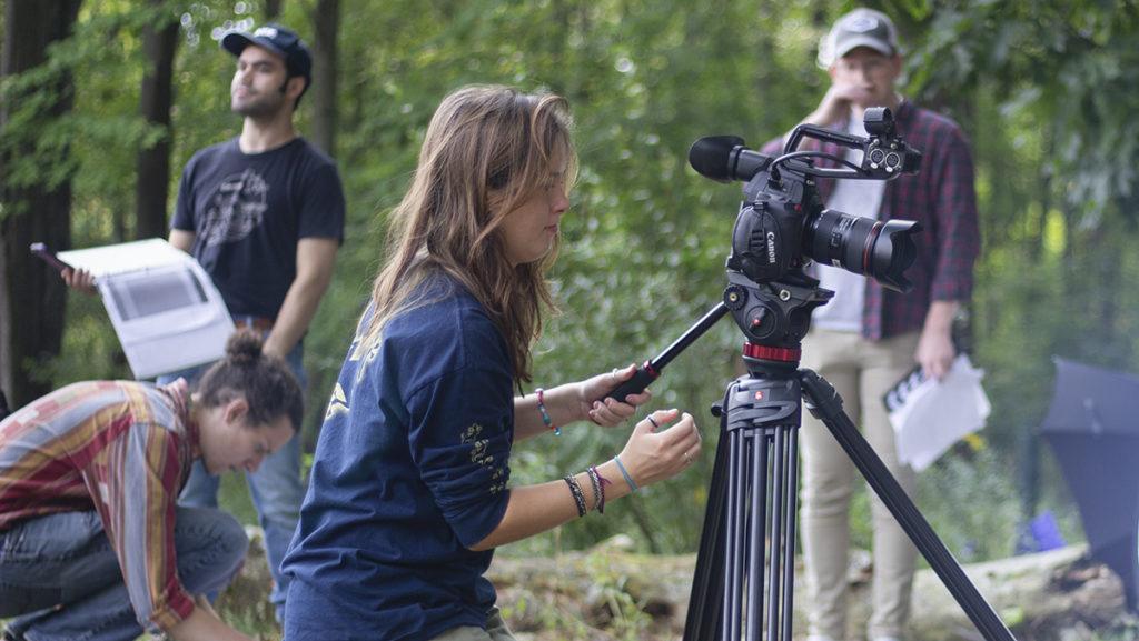 Senior Lili Geho, director of photography for the student film “Elwood,” sets up a shot Sept. 12 in the Ithaca College Natural Lands on the first day of shooting the film. The film is directed by senior Liam Wurtz and produced by senior Anthony Boccia.
