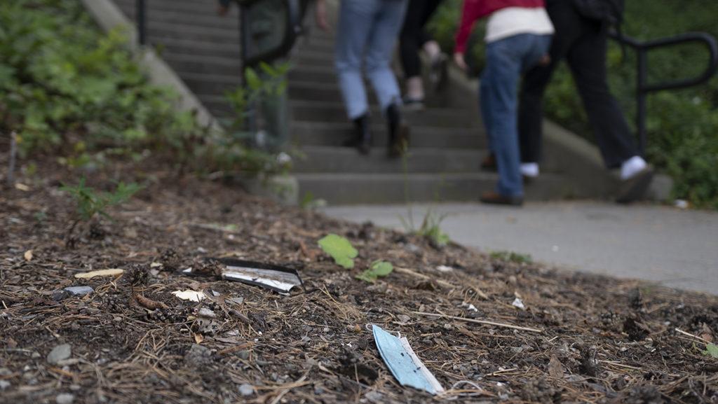 All around the Ithaca College campus, disposable masks are flattened to the ground, soggy with rain; wrappers are tangled in bushes and plastic cups lay tipped on their sides, attracting insects.