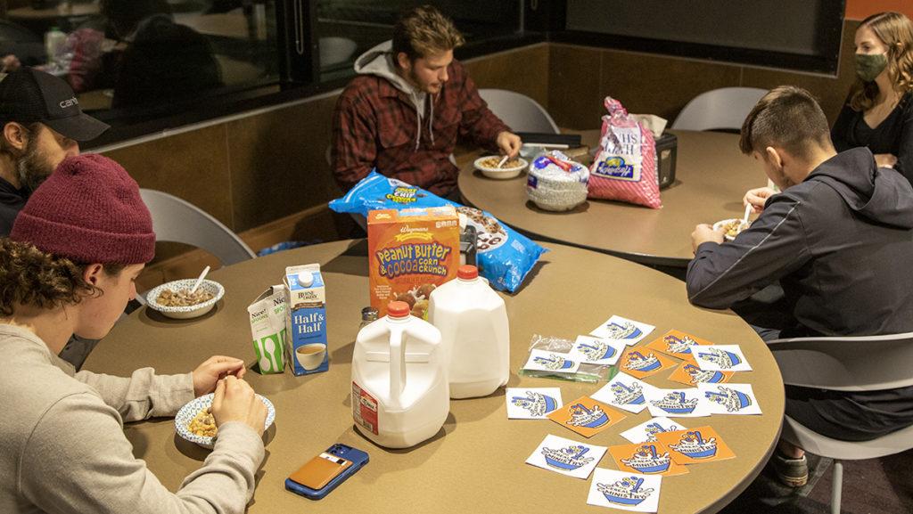 From left, Juniors Will Howell, Nick Daniel and Dylan Race enjoy their favorite cereals before they begin Bible readings at Cereal Ministry Club Nov. 18 in the Campus Center Dining Hall.