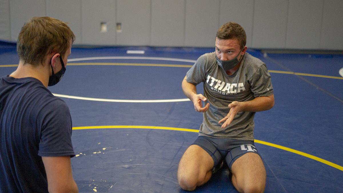 Senior wrestler transitions from top performer to assistant coach