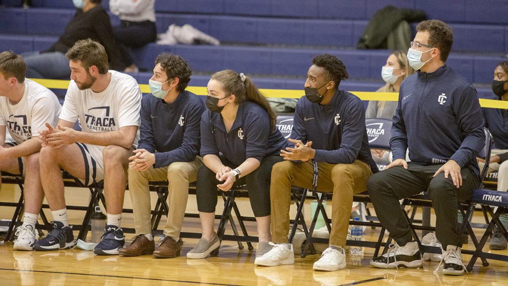 In blue from left, junior James Dimeo, freshmen Sara Hunter and Tim Cheeseboro and junior Lucas Jafet work as student managers for the Ithaca College mens basketball team. The four work with the team during home games and practices.