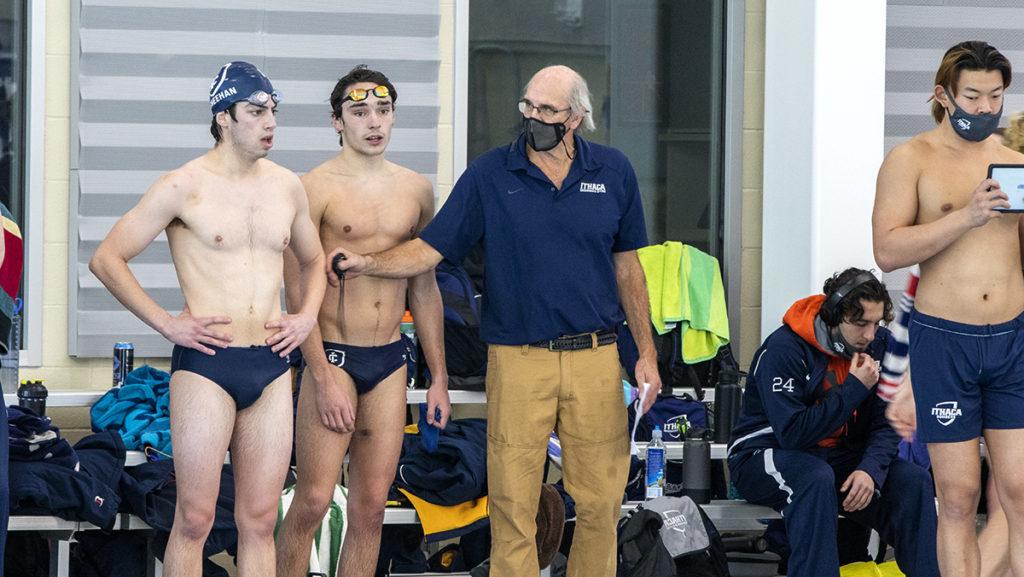 From left, senior Michael Sheehan, freshman Ryan Pillion and Kevin Markwardt, head coach of the mens and womens swimming and diving teams stand on the deck at Kelsey Partridge Bird Natatorium.