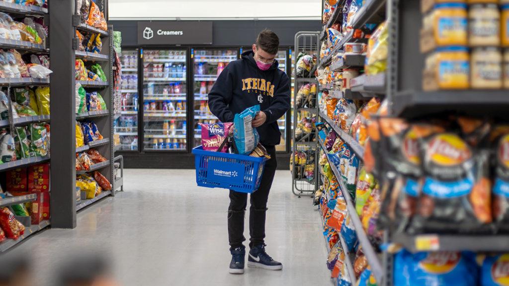 Freshman Jem Taylor-Minier gets groceries from Walmart during a time of rising food prices. College students have been hit hard by inflation, especially with student loans.