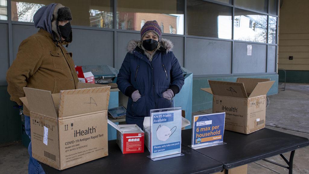 From left, Rich Recchia and Teresa Vadakin distributed free COVID-19 rapid tests to the Ithaca community Feb. 18 at the Tompkins County Public Library.