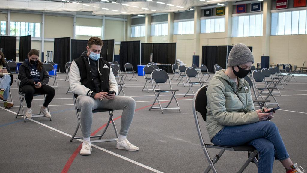 From left, freshman Alexia Michitti, junior Ben Gutchess and freshman Helen Adair wait for their COVID-19 test results during Spring 2022 check-in.