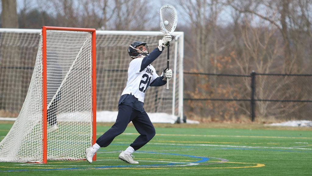 Junior Ryan LaForty, who has started 12 games at goalie for the Ithaca College men’s lacrosse team this season, warms up for a game against Nazareth College on March 23 at Higgins Stadium. 