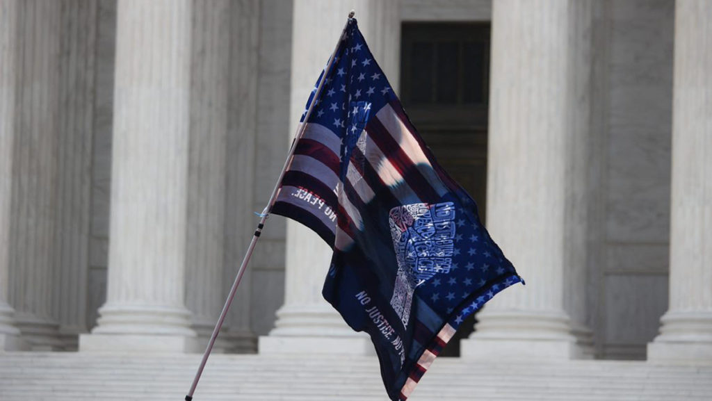 A flag flies in front of the U.S. Supreme Court that reads No Justice, No Peace, after the decision of Dobbs v. Jackson Womens Health Organization was released which also overturned Roe v. Wade. 
