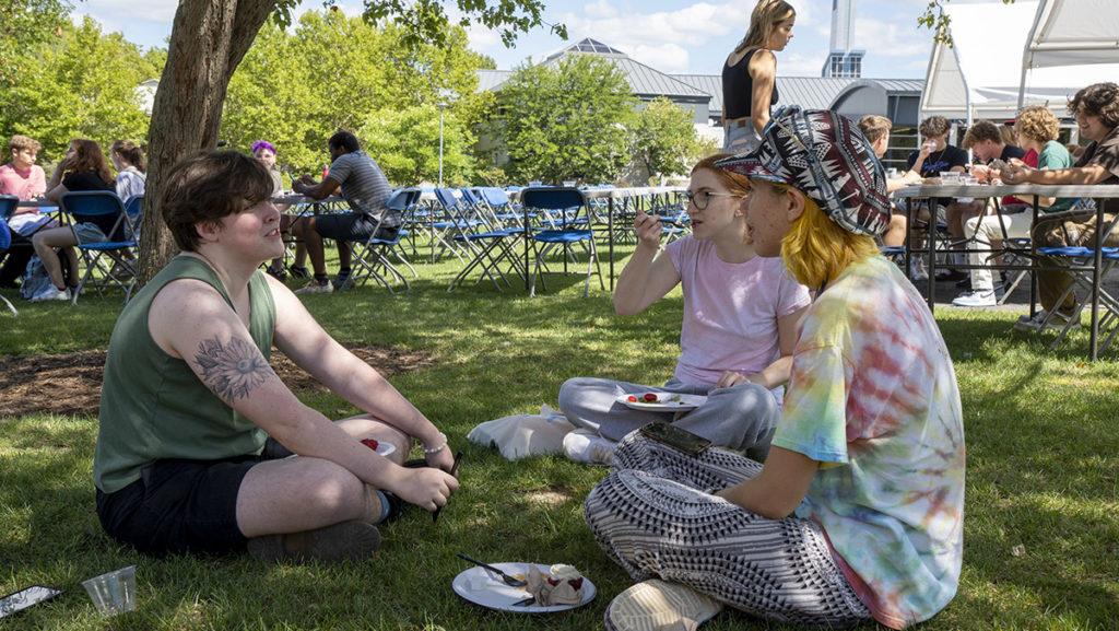 On Aug. 27, from left, sit sophomores James Thacher, Natalie Lewand and Stella Connelly enjoying a conversation at the picnic on the Campus Center Quad.
