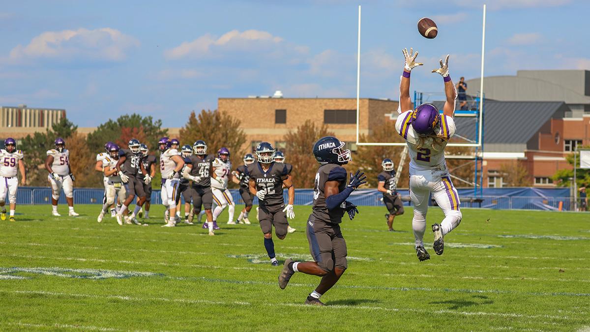 Alfred University senior wide receiver Jacob Kelsey leaps for a pass with Bombers senior defender Tamir Rowser in coverage. Nolan Saunders/The Ithacan