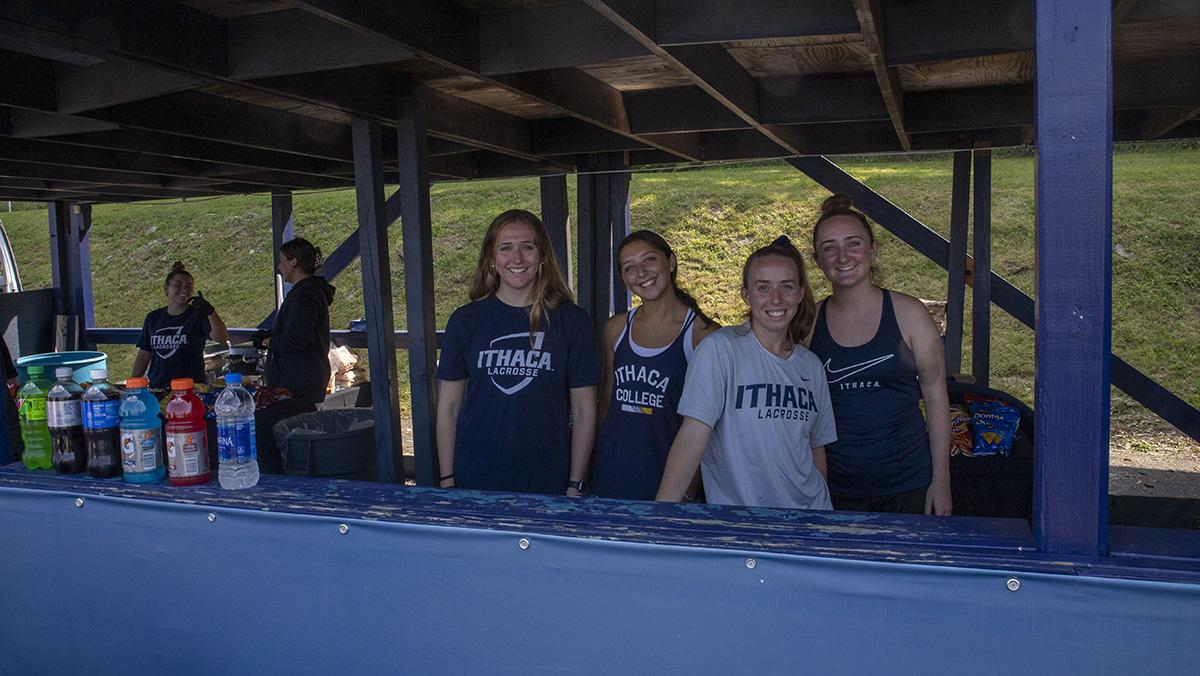 From left, sophomore Caroline Wise, junior Lexi Kellish, and sophomores Liv Puppo and Kristina Rae of the women's lacrosse team worked at the concession stand during the game. Jadyn Davis/The Ithacan