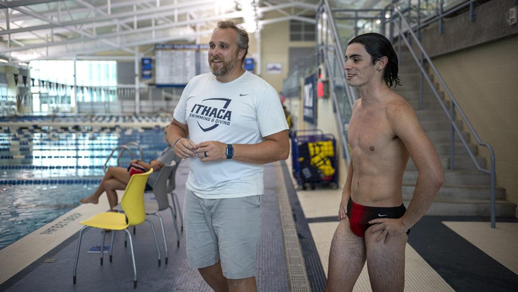 From left Chris Griffin, aquatics coordinator and diving coach for the men’s swimming and diving team, and first-year student Robert Mattesky watch the pool for the springboard diving class.