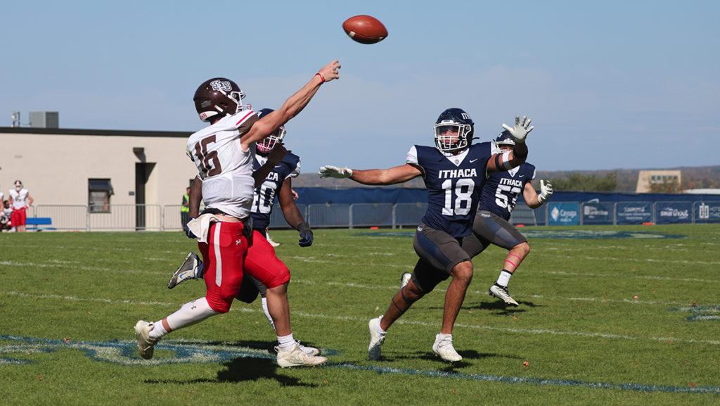 From left, Saints sophomore quarterback Daniel Lawther looks to pass the ball downfield as senior defensive back Ben Stola looks to get a hand on the football while senior linebacker Matt Desimpliciis gets upfield.