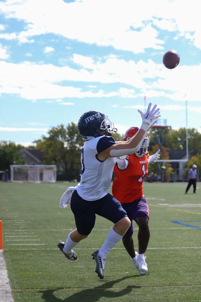 Junior wide receiver Sam Kline of the Bombers reaches for a pass with Hobart College senior defender Abdoulaye Diallo in coverage. Nolan Saunders/The Ithacan
