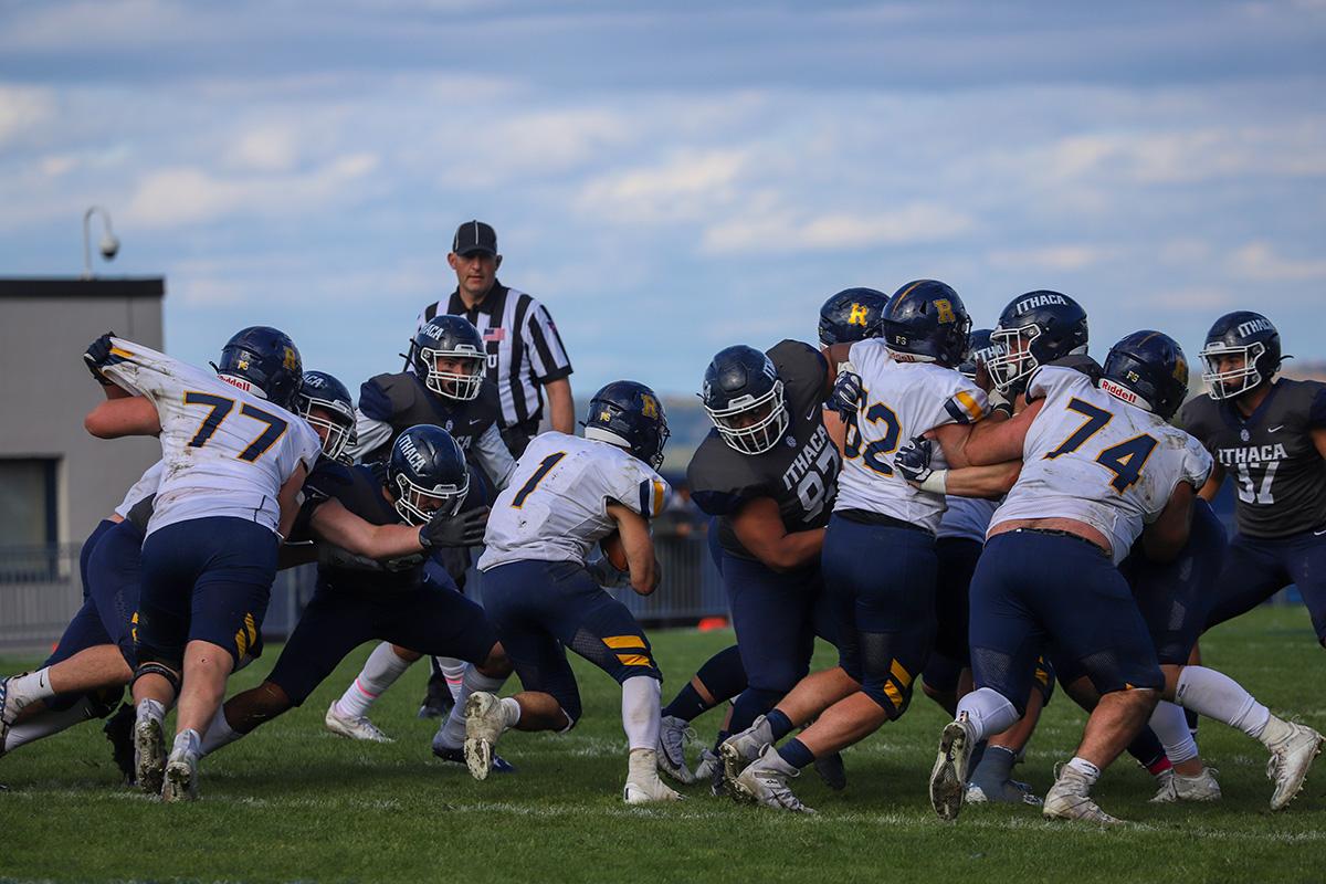 University of Rochester junior running back Daniel Papantonis runs into a horde of Bombers defenders at the line of scrimmage. Brendan Iannucci/The Ithacan