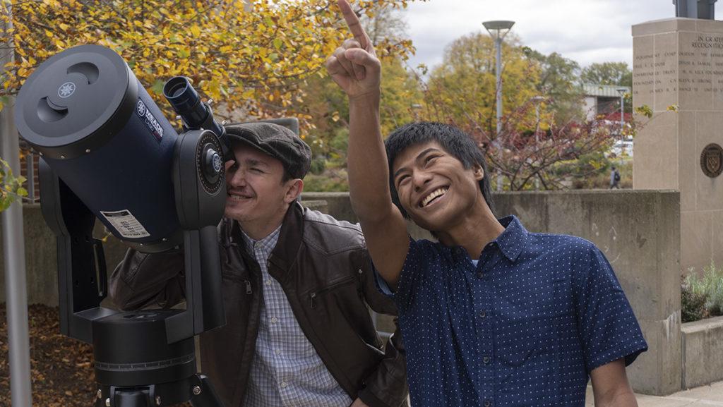 From left, juniors Mikolaj Konieczny and Wesley Czubryt-Ogino use a telescope to look into the sky. The revitalized astronomy club is aiming to bring more students from all academic backgrounds.