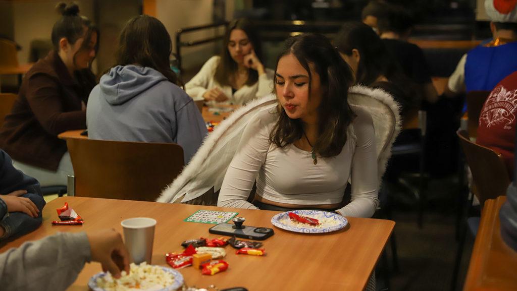Junior Carolina Iribarren fills out a bingo card during Boo Bingo Night on Oct. 22 in IC Square, which was hosted by the Office of Student Engagement and was open for all students to attend. Students received food and prizes. 