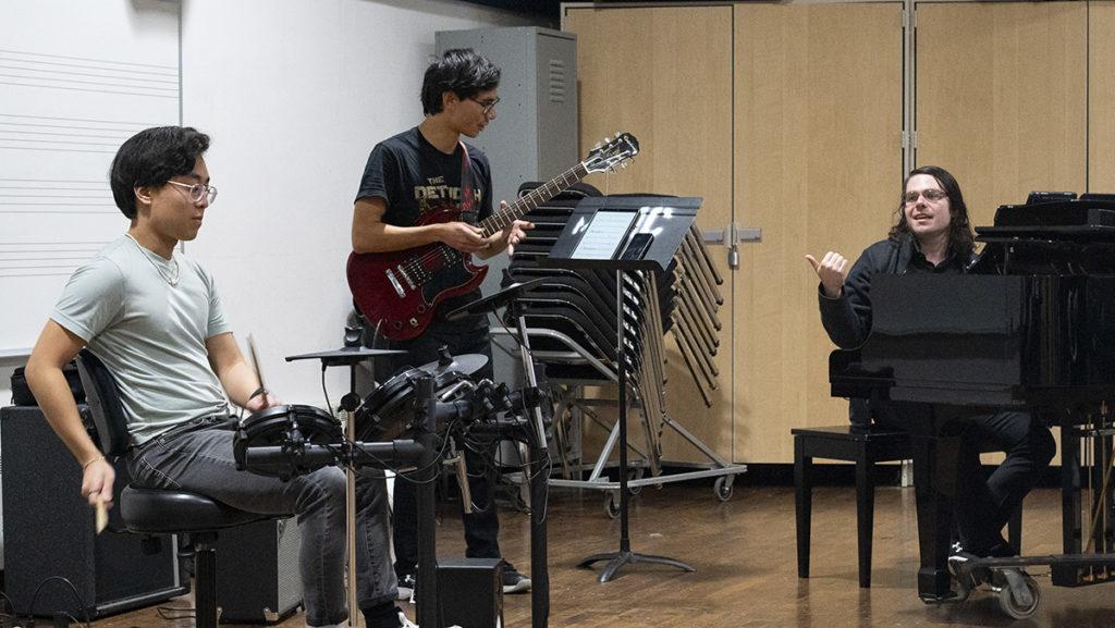 From left, sophomore Yushi Portwood, Cameron Narimanian ’22 and senior Ben Marcarell practice for their last show coming up Oct. 29. The three comprise the college rock band Port MacNam.