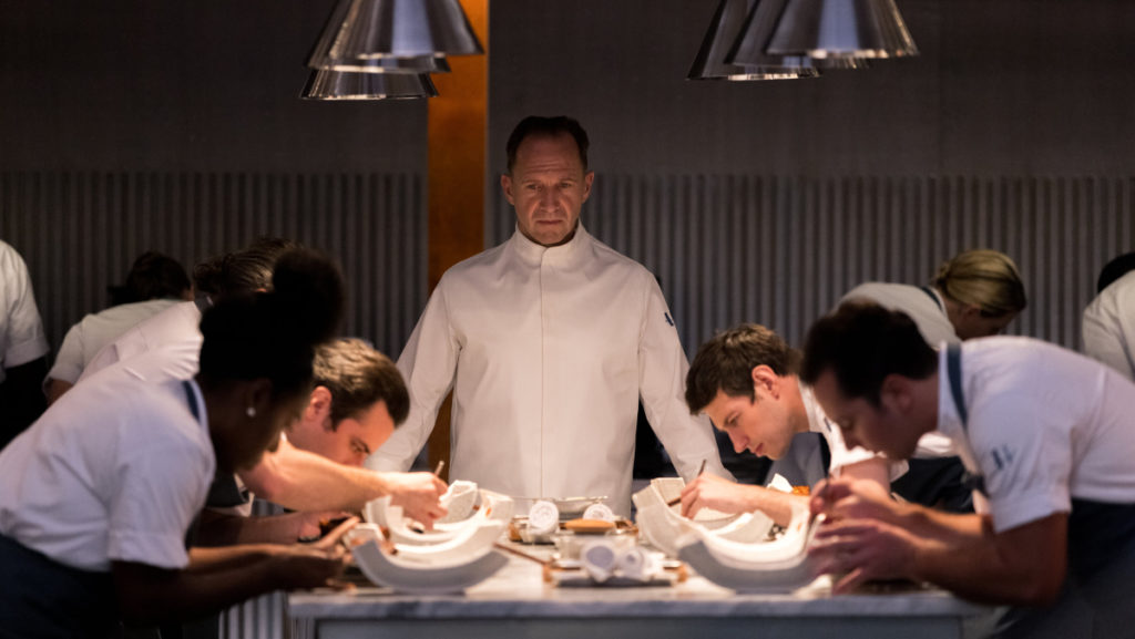 Chef Julian Slowik (Ralph Fiennes) watches as his devious menu is prepared for the unsuspecting guests in The Menu.