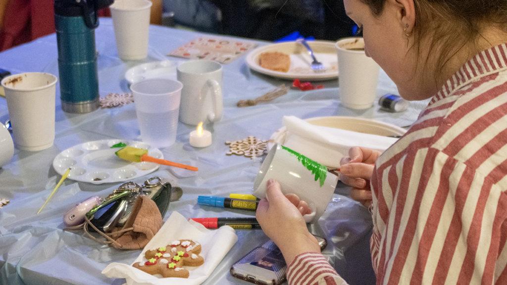 Sophomore Meredith Ford paints on a mug at the PJs and Pancakes event hosted by the Student Activities Board on Dec. 2. The event allowed students to destress before finals with holiday activities. 