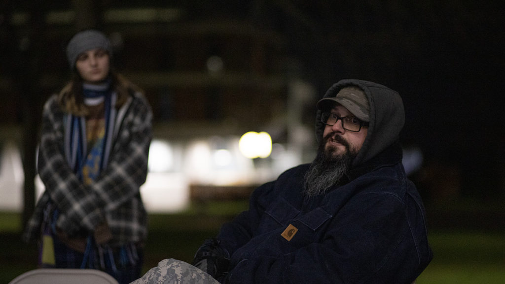 From left, sophomore Sarena Geadah listens as Mike Foster, community manager for Second Wind Cottages, discusses the organizations efforts at the Sleepout for Second Wind on Dec. 2.