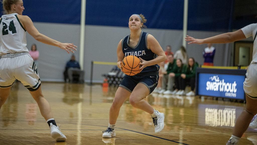 From left, William Smith sophomore forward Maddie Patrick tries to defend against Ithaca College junior guard Hannah Polce.