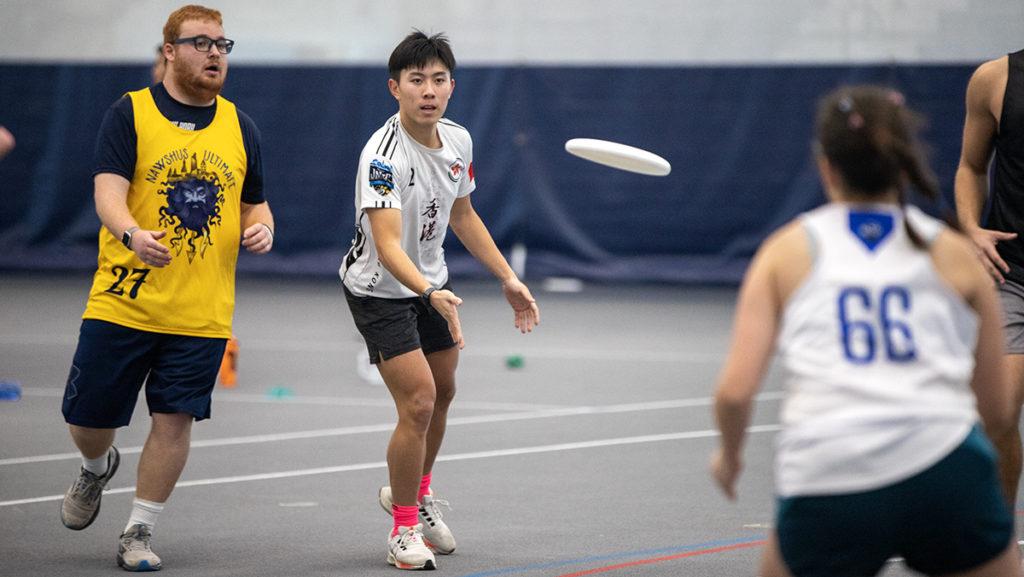 From left, Cornell University sophomore Ethan Lau and Ithaca College senior Ellen Chapman play on the same team during the Frozone ultimate frisbee tournament bringing both colleges together to celebrate the sport Jan. 28.