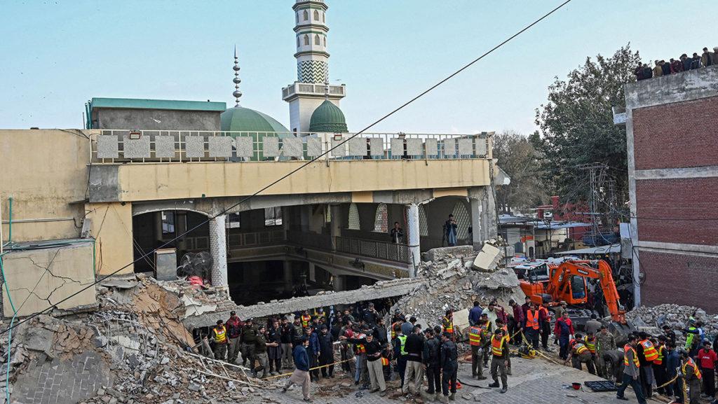 Rescue workers prepare to search for blast victims in the rubble of a police headquarters mosque in Peshawar on Jan. 30 after a suicide bombing. As of Jan. 31, the bombing has killed at least 100 people and wounded at least 225.