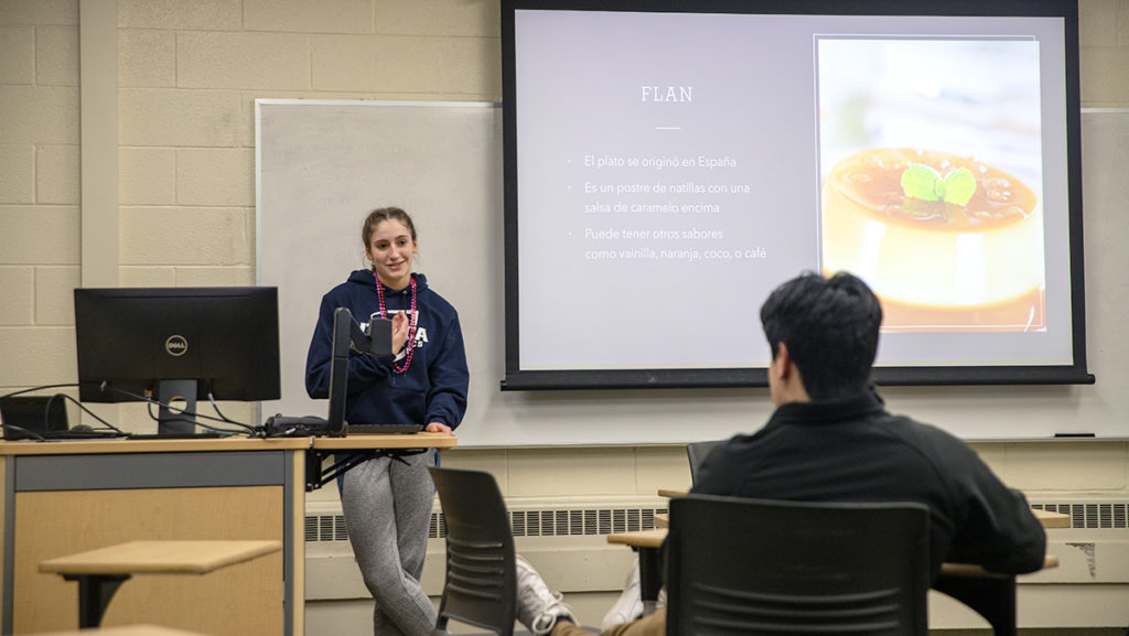 From left, sophomore Marlena Bailey and senior Alonso Gonzalez Raynaud discuss food during the Tertulias conversation group meeting. The group aims to help students practice speaking Spanish.