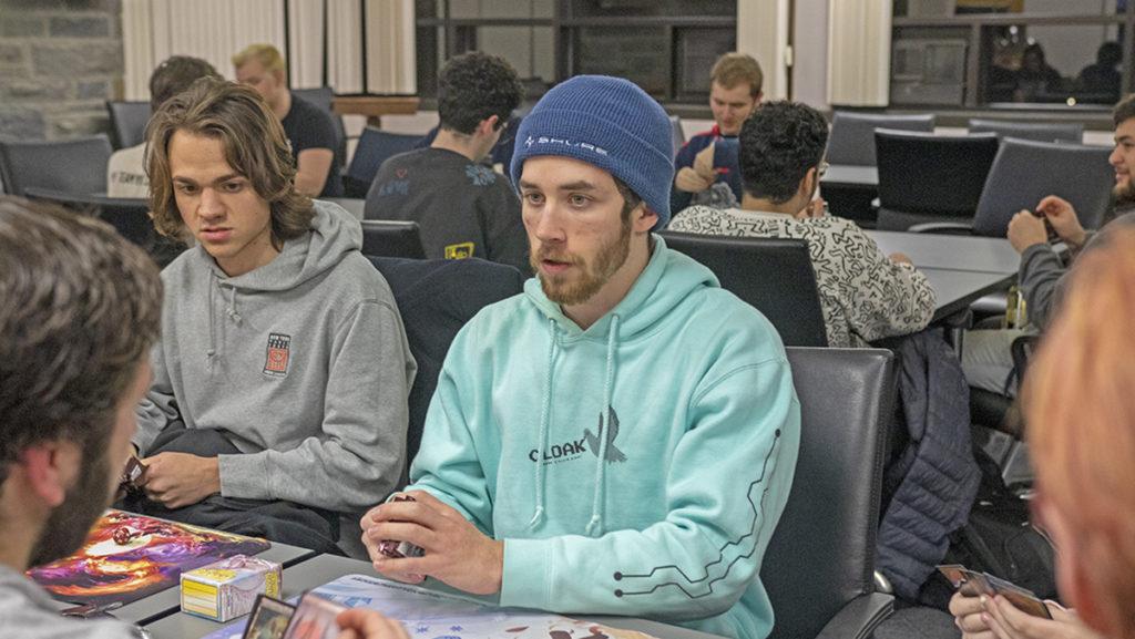 From left, sophomores Holden Prescott and James Flanagan shuffle a deck of cards before the start of their match Feb. 17. The Ithaca College Trading Card Game Club hosted a Magic The Gathering draft in the Taughannock Falls room. 