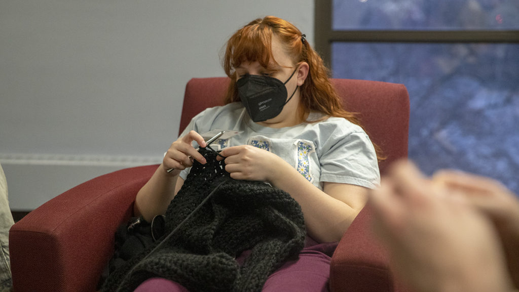 Junior Gwyneth Cole works on a crochet project during a craft night held by Sigma Alpha Iota on Feb. 5 in the Terrace nine lounge. The Epsilon chapter for the international music fraternity for non-male identifying students is located in the same building. 