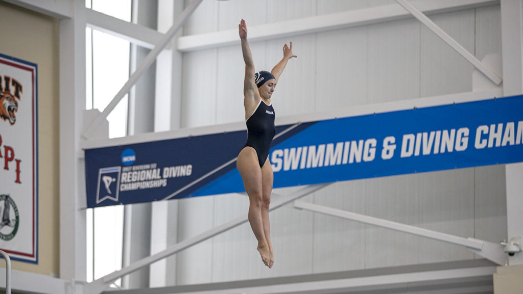 Senior diver Karalyn Pawcio begins her dive at the Geneca Diving Invitational on Feb. 4. Pawcio won the 3-meter boards at the meet and came in third for the 1-meter boards.