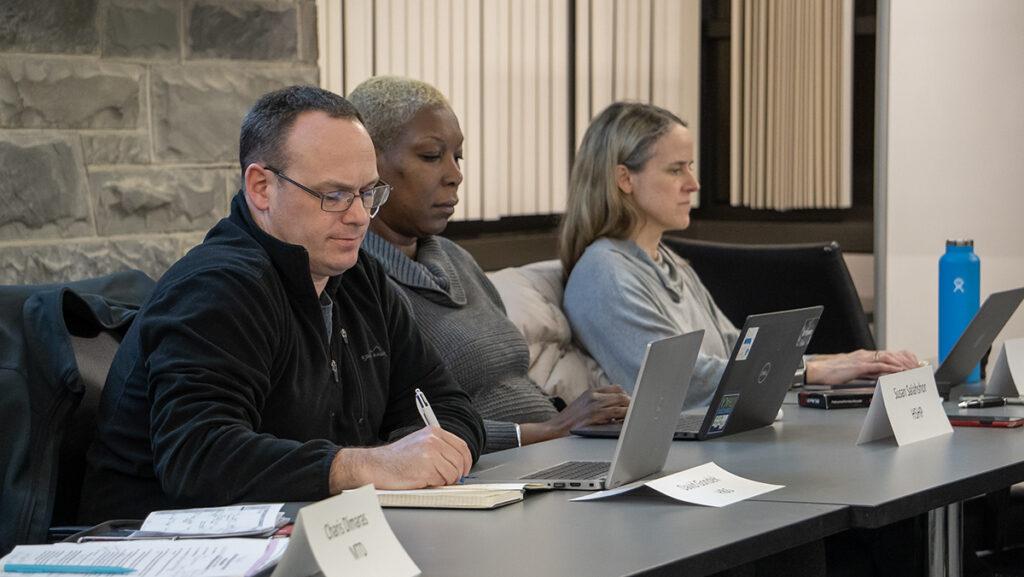 From left, David Gondek, associate professor in the Department of Biology; Susan Salahshor, director of the Physician Assistant Program; and Laura Kuo, health sciences librarian, attend the March 7 Faculty Council meeting.