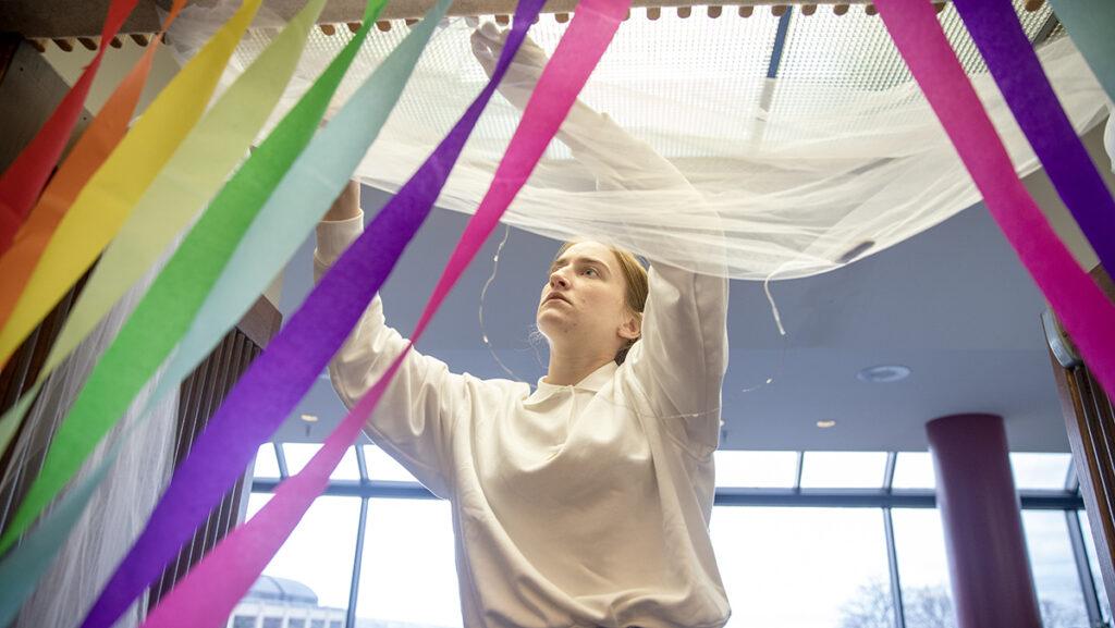 Grace Dosdall, pride fellow at the LGBT Center, helps set up Emerson Suites for the Pride Prom on March 23. The prom was attended by around 120 people.