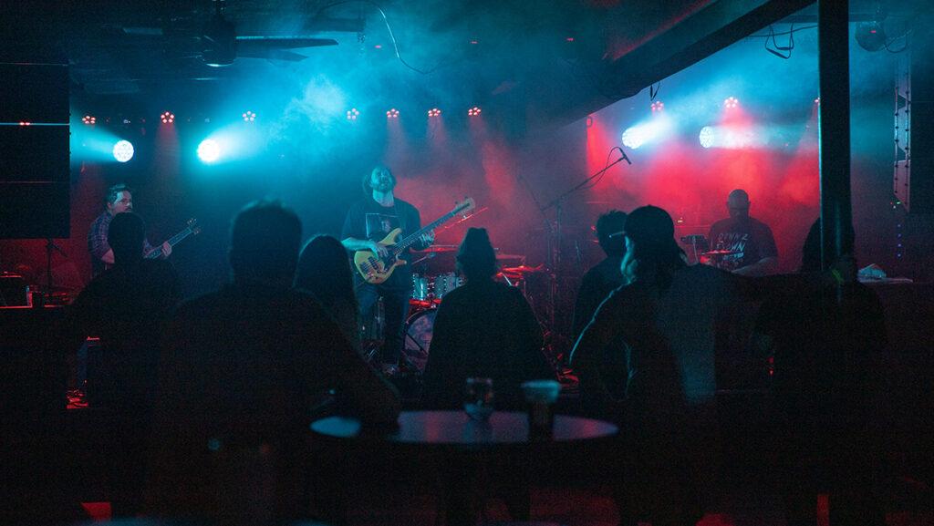 Onlookers watch an electric live performance at Deep Dive. The recently opened waterfront venue serves as an intergenerational hangout spot for both college students and older Ithaca residents.