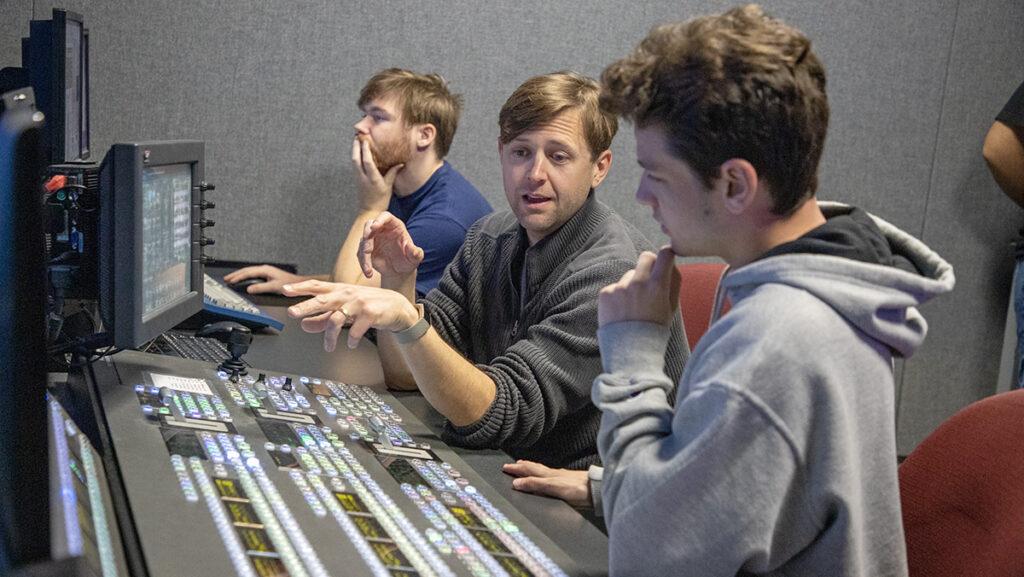 From left, junior Joshua Fuller, Alex Estabrook, instructor of the Esports Content Production class, and sophomore Alex Tchiprout work at the Studio B switcher.