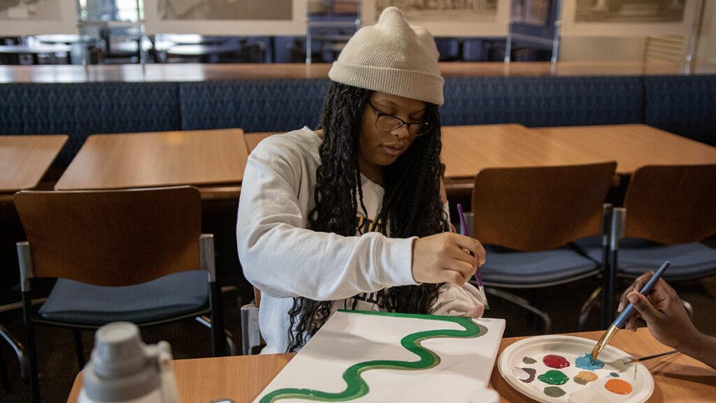 Sophomore Lauren Smith works on creating a masterpiece during a paint and sip event. The events offer people the ability to create their own pieces of art in a relaxed, judgement-free environment.
