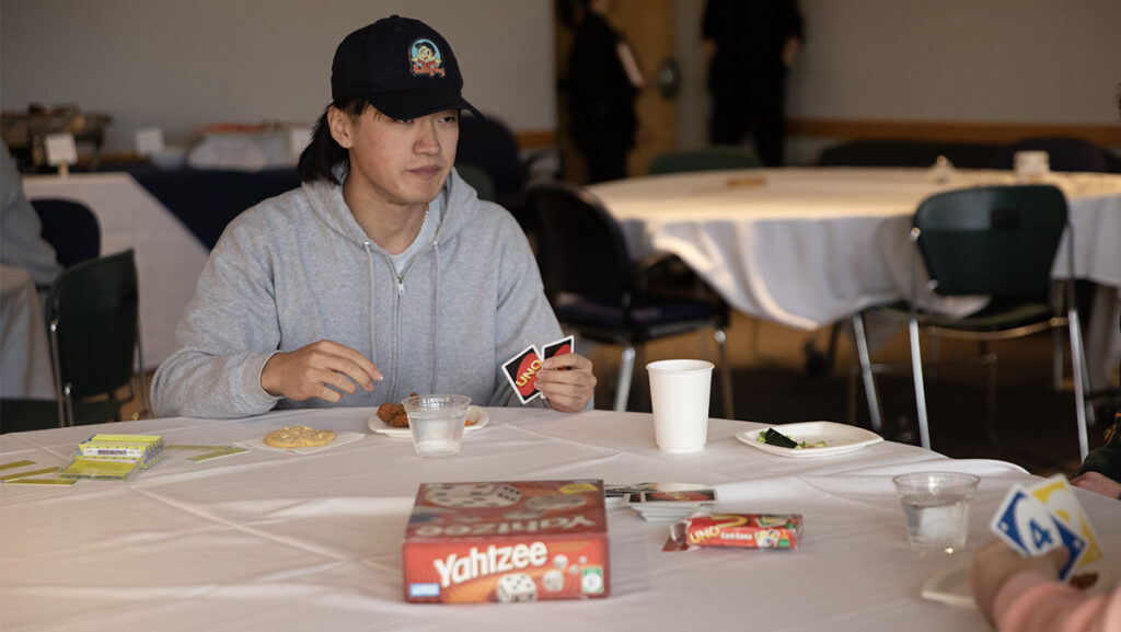 Sophomore Daniel Jin plays Uno at the Room and Board Games: Roommate Mixer event April 1. The event allowed students to meet potential roommates.