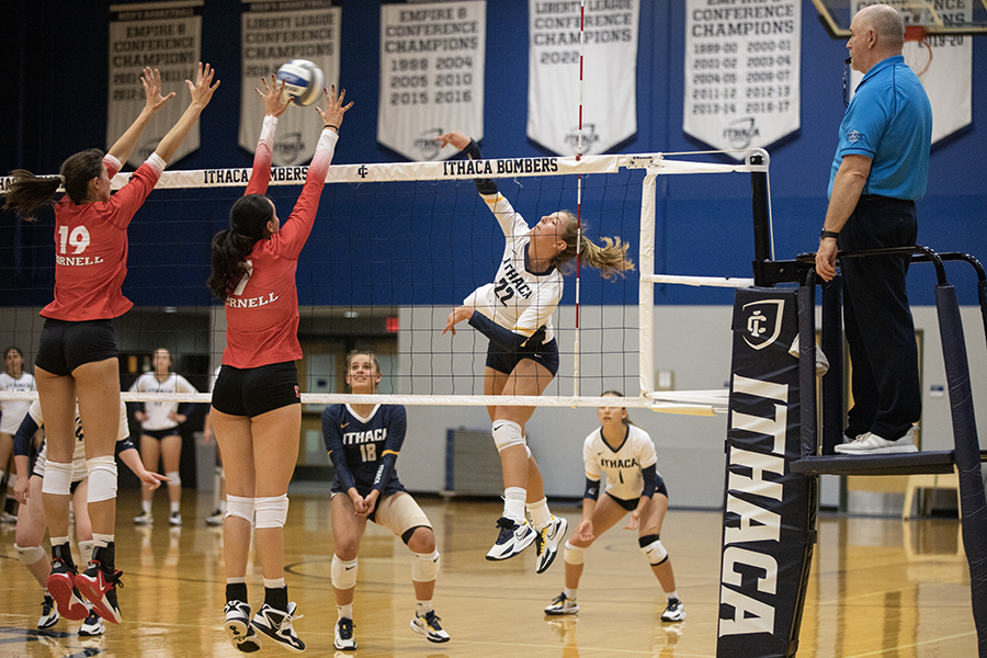 From left, Cornell junior Camryn Carlo and sophomore Doga Ozalp block while Ithaca sophomore Naomi Clauhs spikes and senior Julia Costa and junior Ellie Benedict get ready to defend at the scrimmage between Cornell and Ithaca on Aug. 26. 