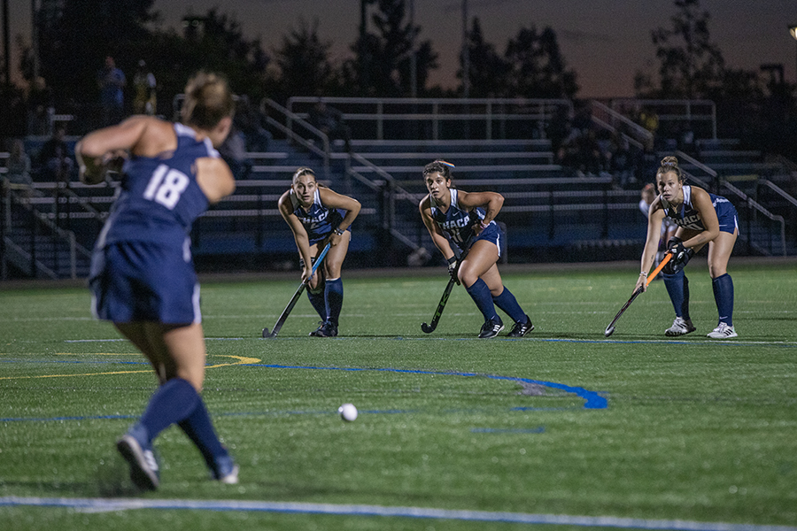 From left, junior midfielder Meara Bury injects the ball during a penalty corner while junior midfielder Catherine Papa and junior strikers Juliana Valli and Emma Garver prepare to attack.
