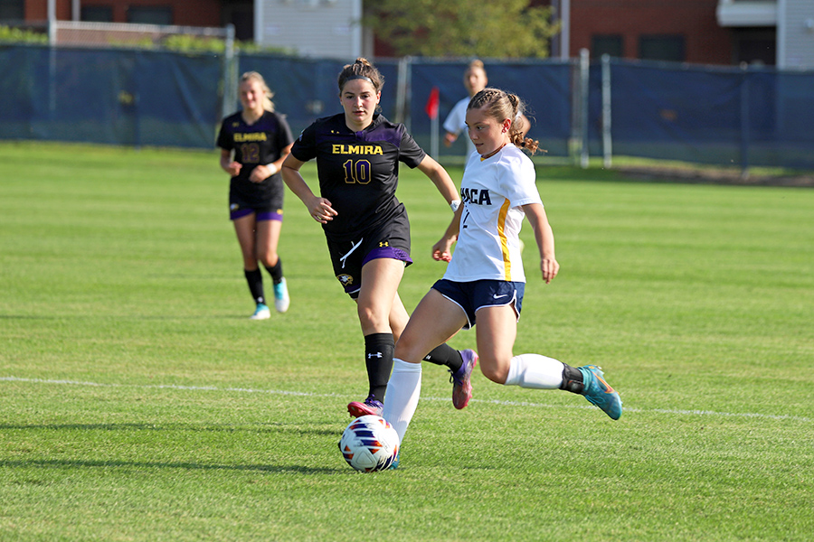 From left, sophomore forward Faith Ingber defends the Bombers sophomore defender Sophia Rosas as she transitions the ball upfield during the Bombers 10–1 win over Elmira College on Sept. 1.