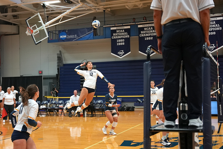From left, senior outside hitter Alexandra Montgomery looks on while first-year outside hitter Gabriella Gonzalez-Abreu goes up to spike the ball.