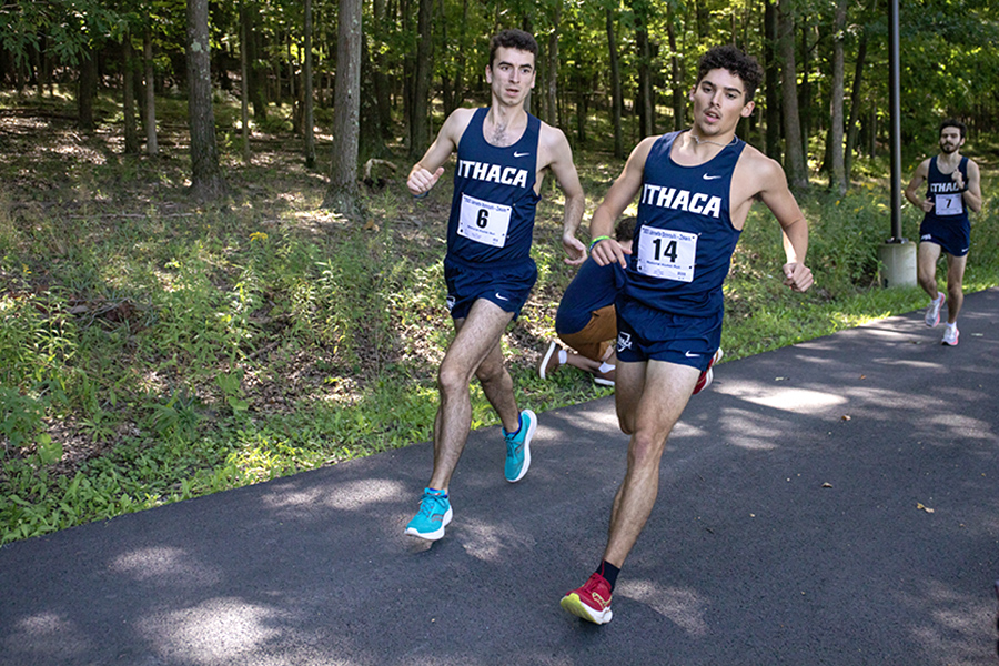 From left, senior Patrick Bierach and sophomore Adam Mocho run side-by-side during the alumni event. Mocho posted a 5k time of 17:19.53.